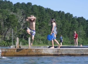 Children leap from the floating dock at Gull Pond in Wellfleet.