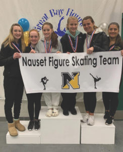 Nauset's new figure skating club posing with a banner