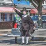 Ken Lonergan, in full town crier costume and face shield, gets heard, pandemic or no. He retired last week. (Photo Nancy Bloom)