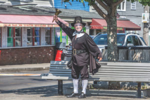 Ken Lonergan, in full town crier costume and face shield, gets heard, pandemic or no. He retired last week. (Photo Nancy Bloom)